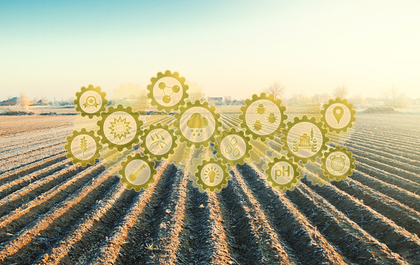The image shows a field with tech icons above it to show how technology has changed farming.