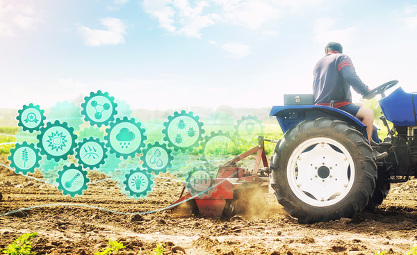 The image shows a tractor ploughing a field with technology icons trailing behind to explain what is precision agriculture.